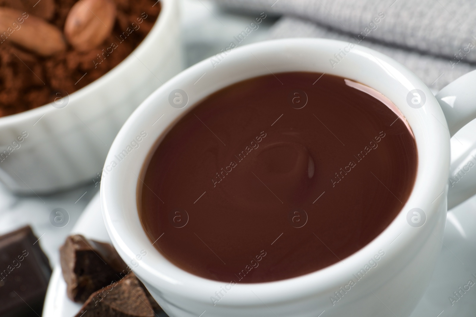 Photo of Yummy hot chocolate in cup on table, closeup