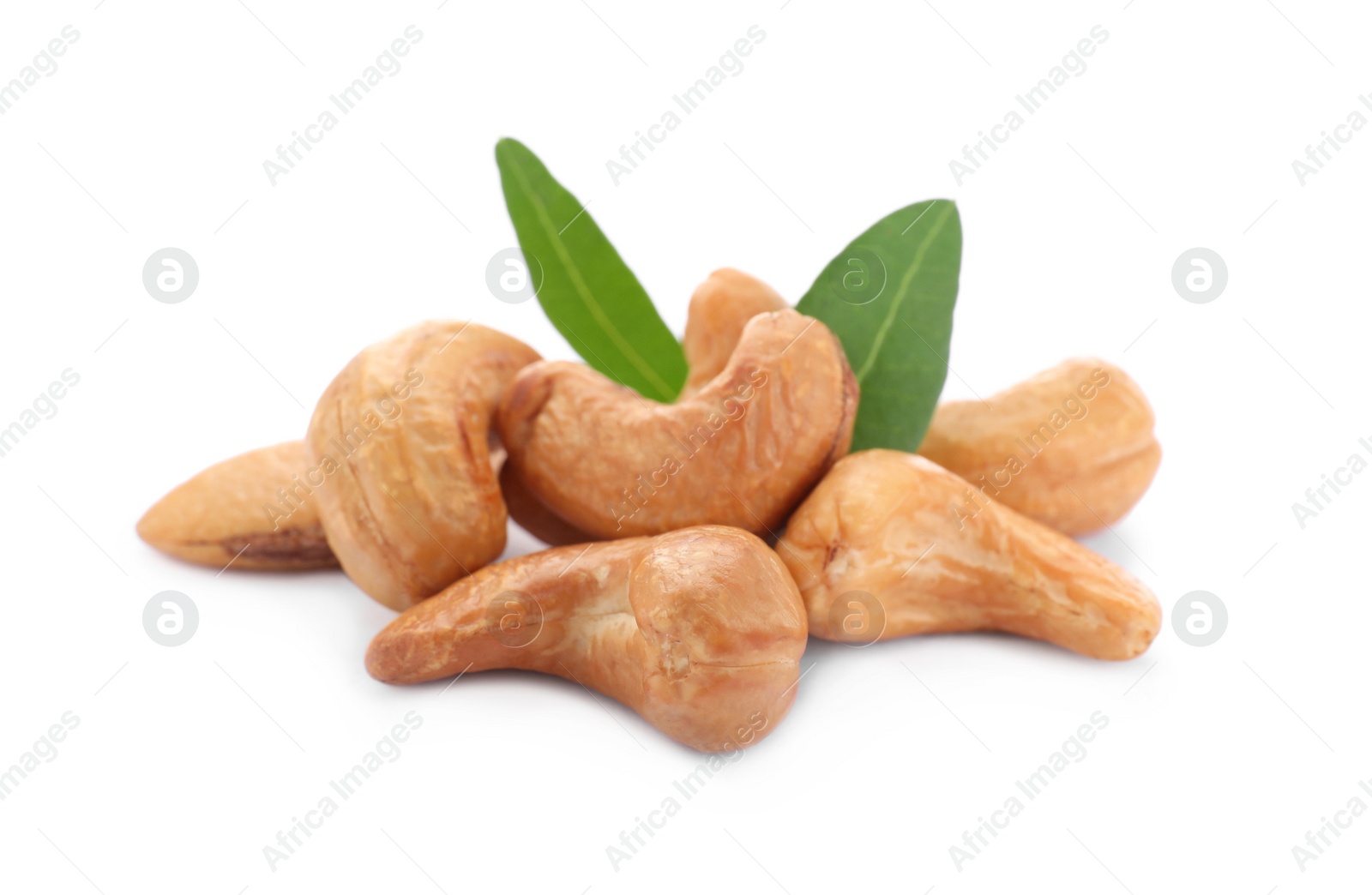 Photo of Pile of tasty organic cashew nuts and green leaves isolated on white