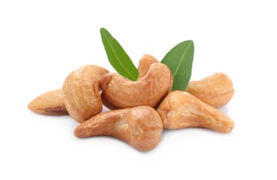 Photo of Pile of tasty organic cashew nuts and green leaves isolated on white