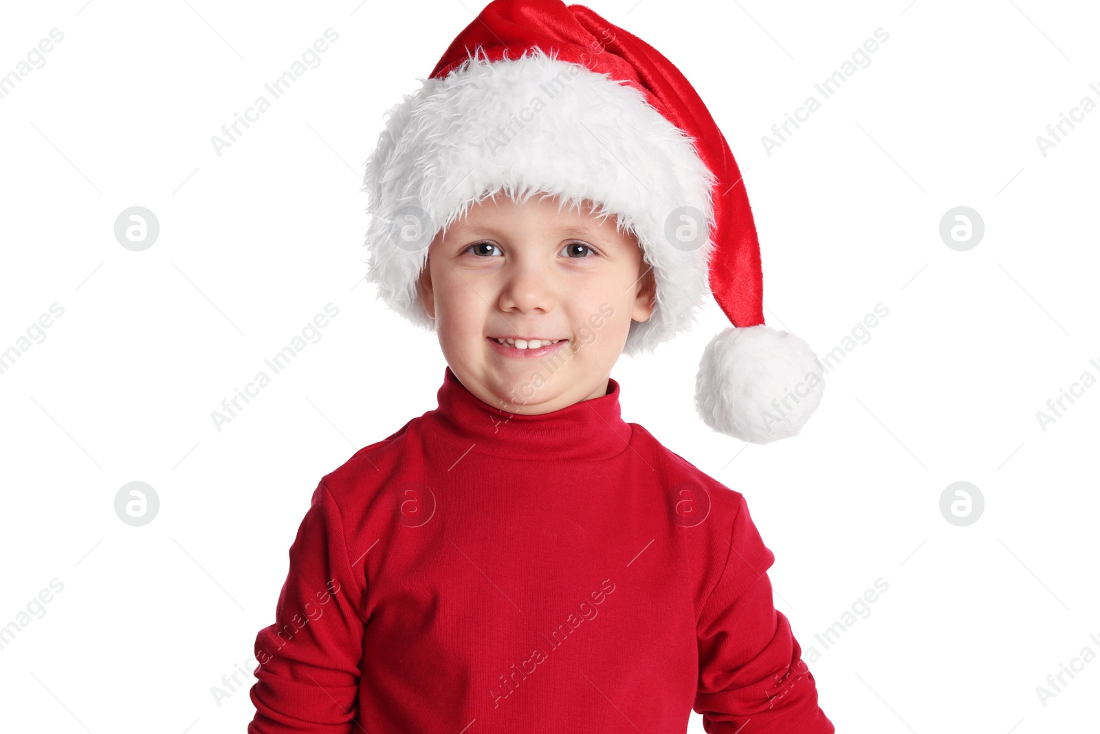 Photo of Cute child in Santa hat on white background. Christmas celebration