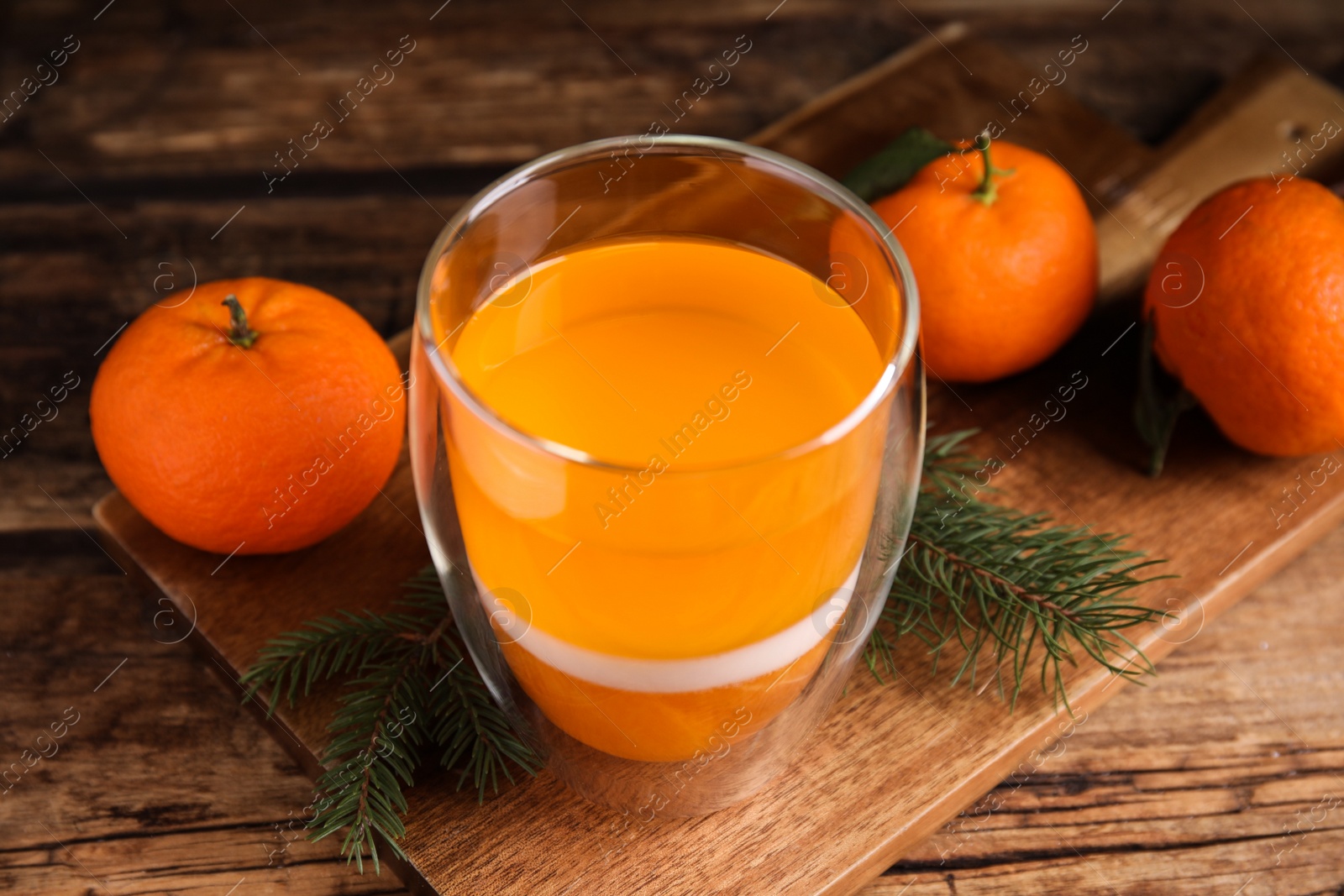 Photo of Delicious tangerine jelly and fresh fruits on wooden table, closeup