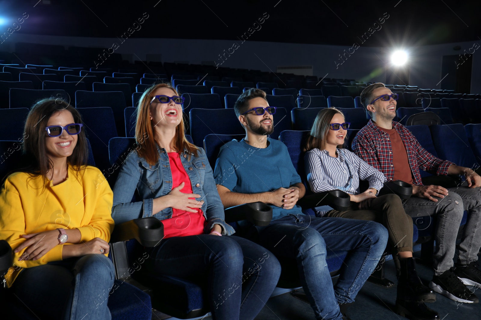 Photo of Young people watching movie in cinema theatre