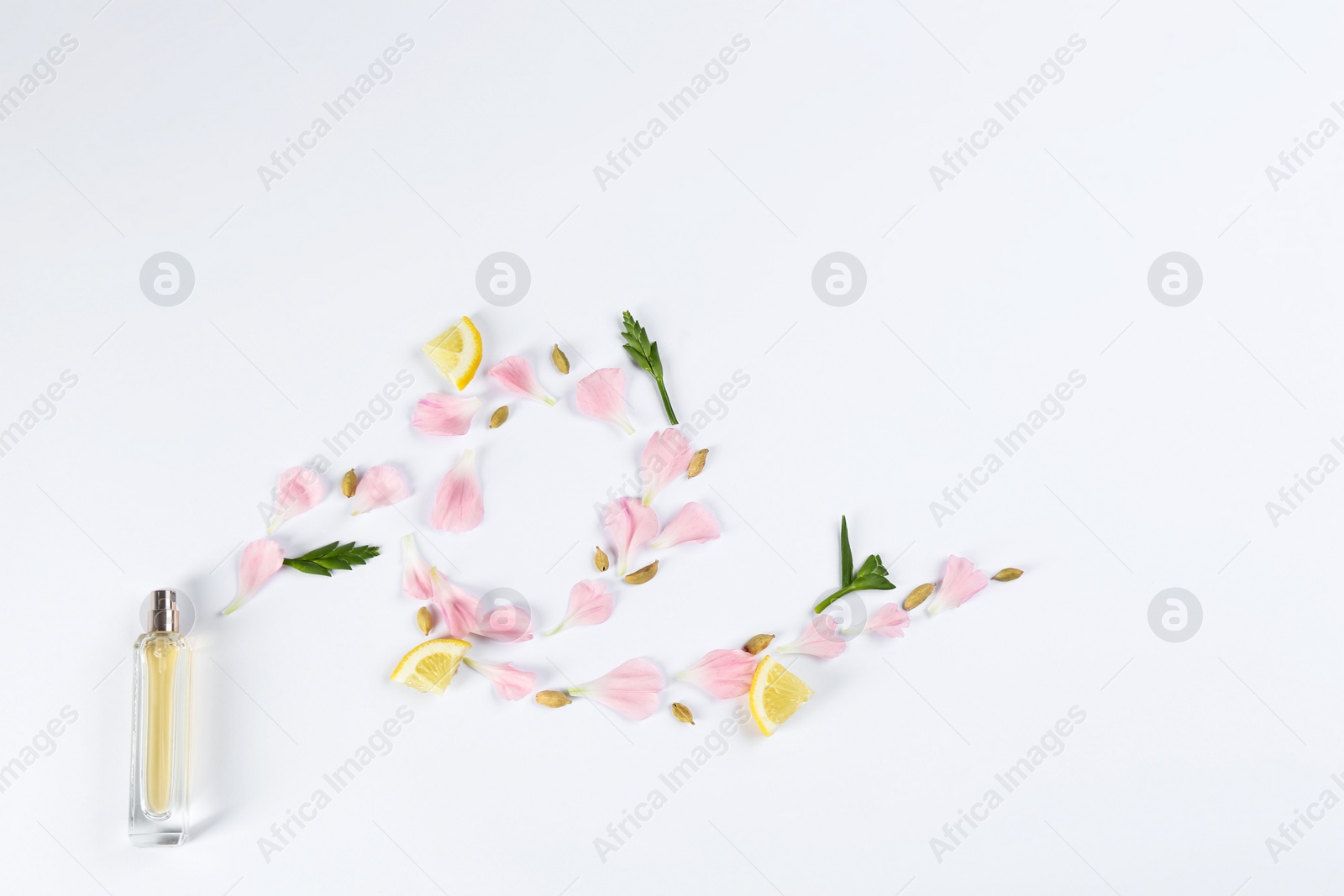 Photo of Flat lay composition with bottle of perfume on white background