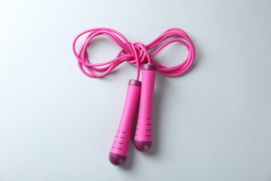 Photo of Skipping rope on white background, top view. Sports equipment