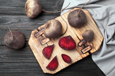 Photo of Flat lay composition with ripe beets on wooden background