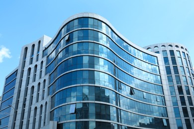 Photo of Modern building against blue sky, low angle view