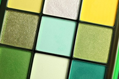 Photo of Beautiful palette of colorful eyeshadows as background, closeup