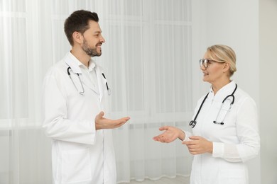 Photo of Professional doctors having discussion in office hall