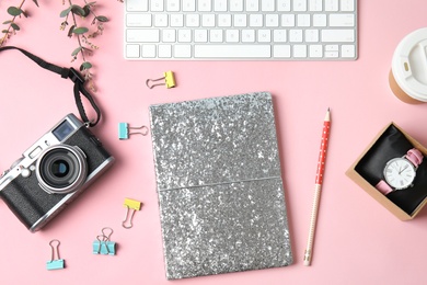 Photo of Blogger's workplace with notebook, keyboard and camera on color background, flat lay