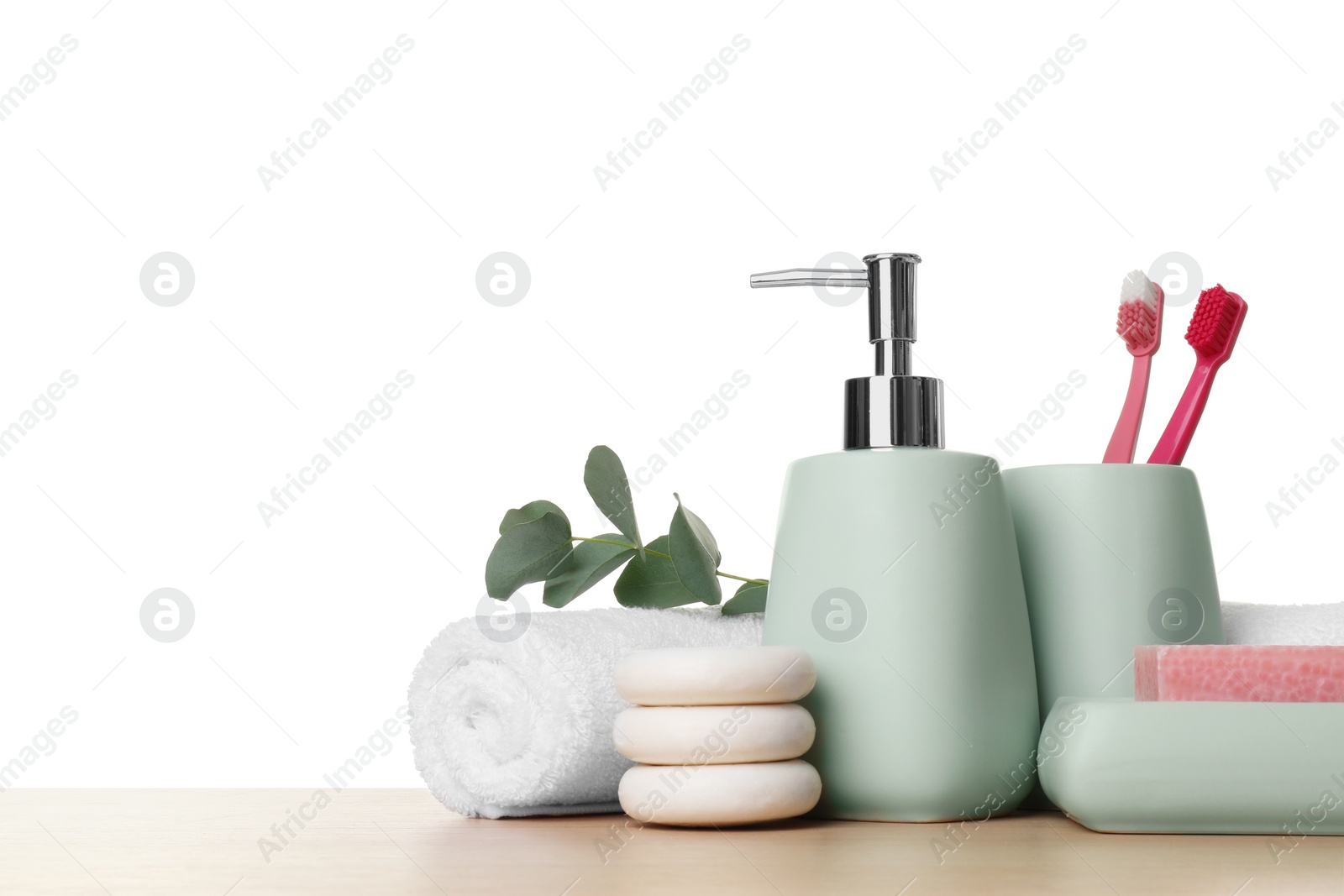 Photo of Bath accessories. Different personal care products and eucalyptus branch on wooden table against white background. Space for text