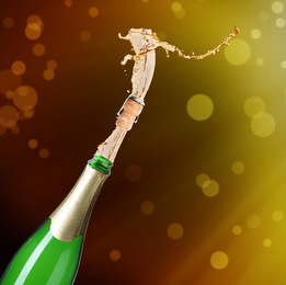 Image of Champagne splashing out of bottle on color background 
