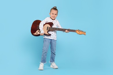 Photo of Happy girl with electric guitar on turquoise background