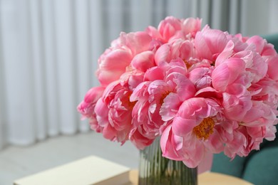 Photo of Beautiful bouquet of pink peonies in vase indoors, closeup. Space for text
