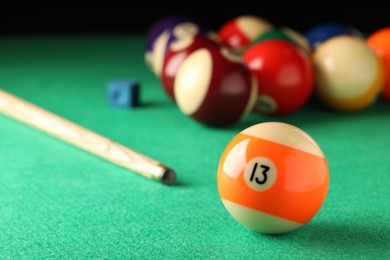 Billiard ball with number 13 on green table, space for text