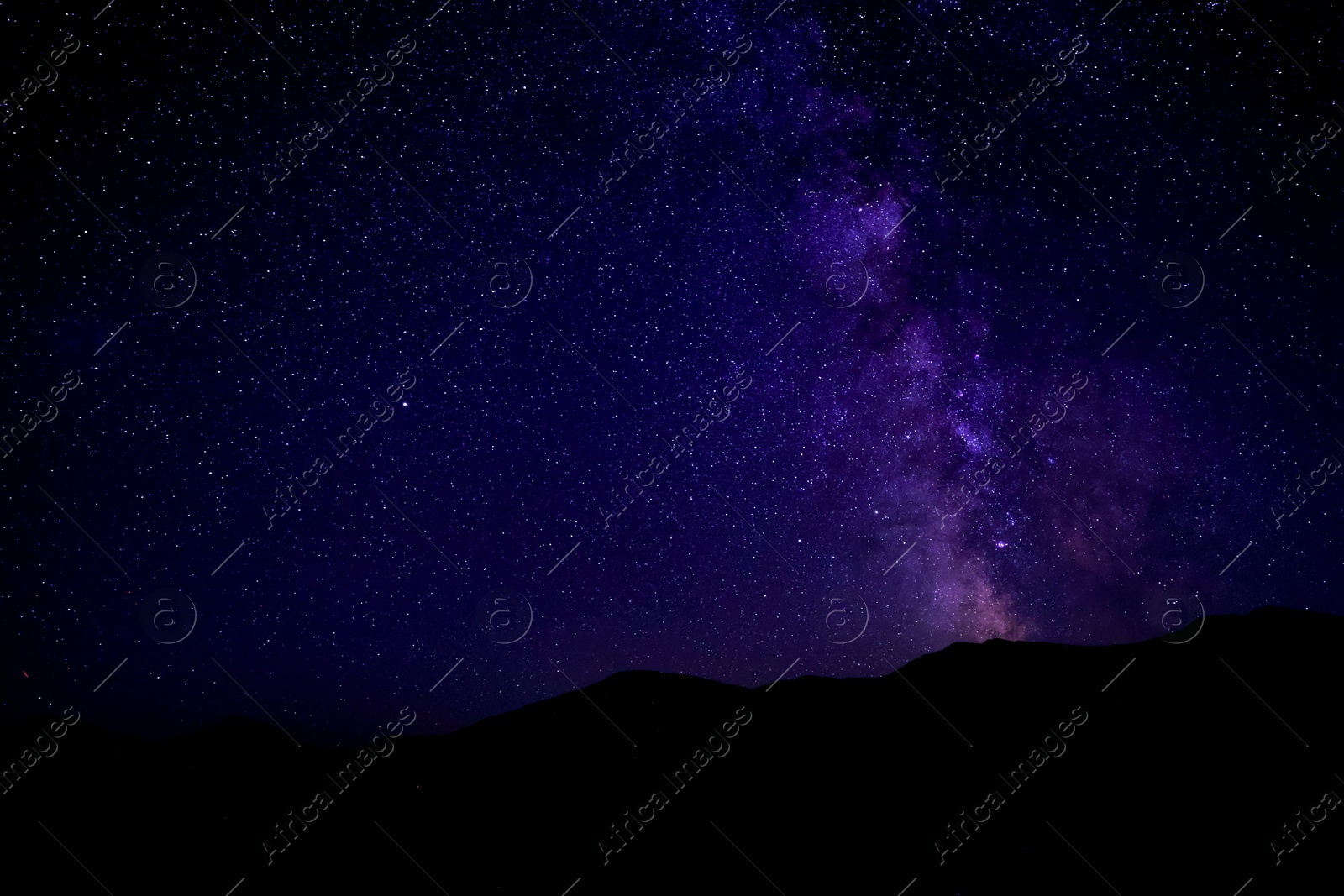 Image of Sky with twinkling stars over mountains at night