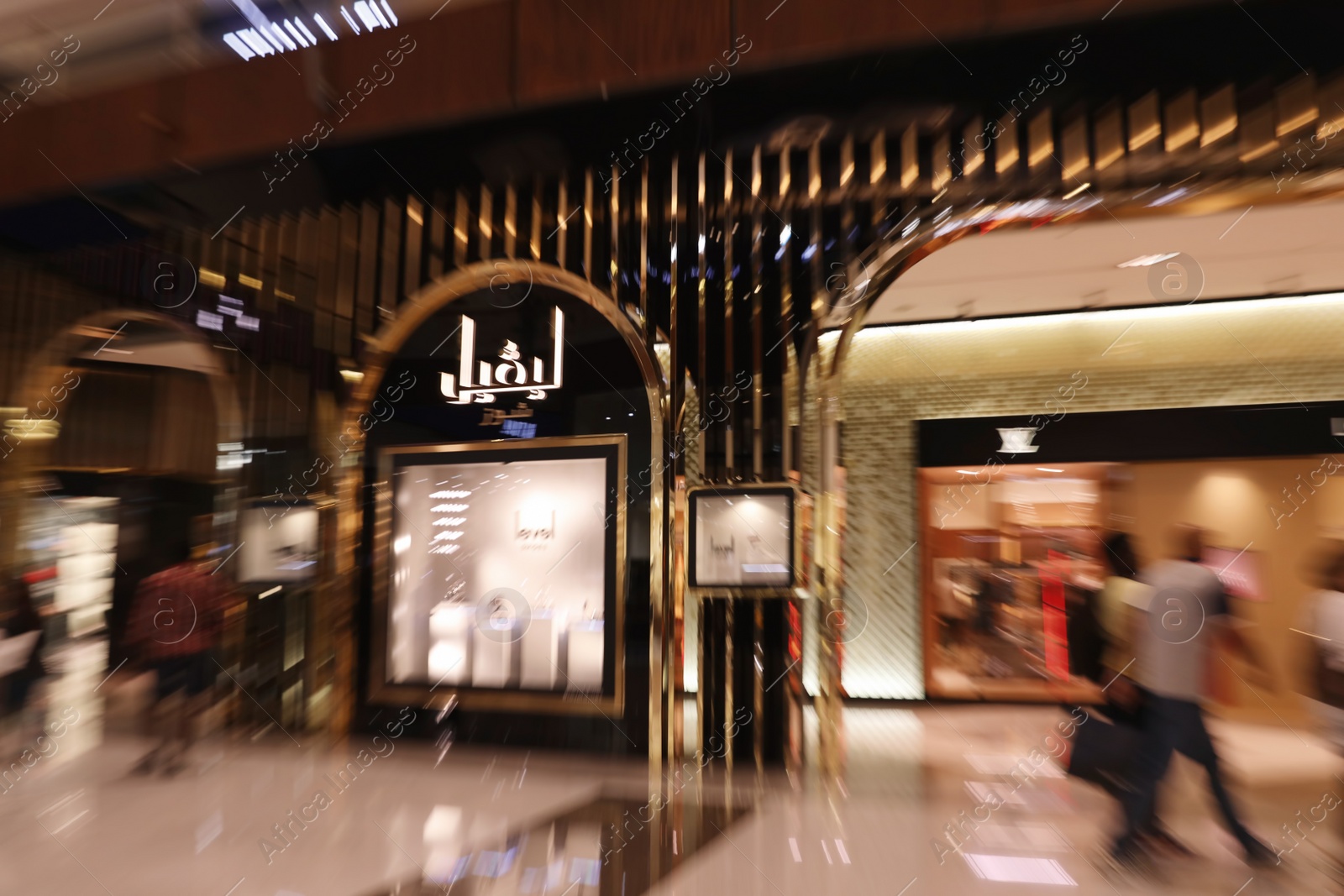 Photo of DUBAI, UNITED ARAB EMIRATES - NOVEMBER 04, 2018: Interior of luxury shopping mall, motion blur