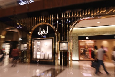 Photo of DUBAI, UNITED ARAB EMIRATES - NOVEMBER 04, 2018: Interior of luxury shopping mall, motion blur