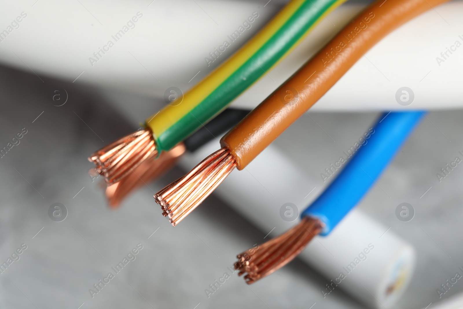 Photo of Colorful electrical wires on blurred background, closeup