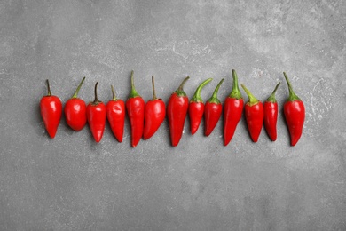 Photo of Flat lay composition with fresh chili peppers on gray background