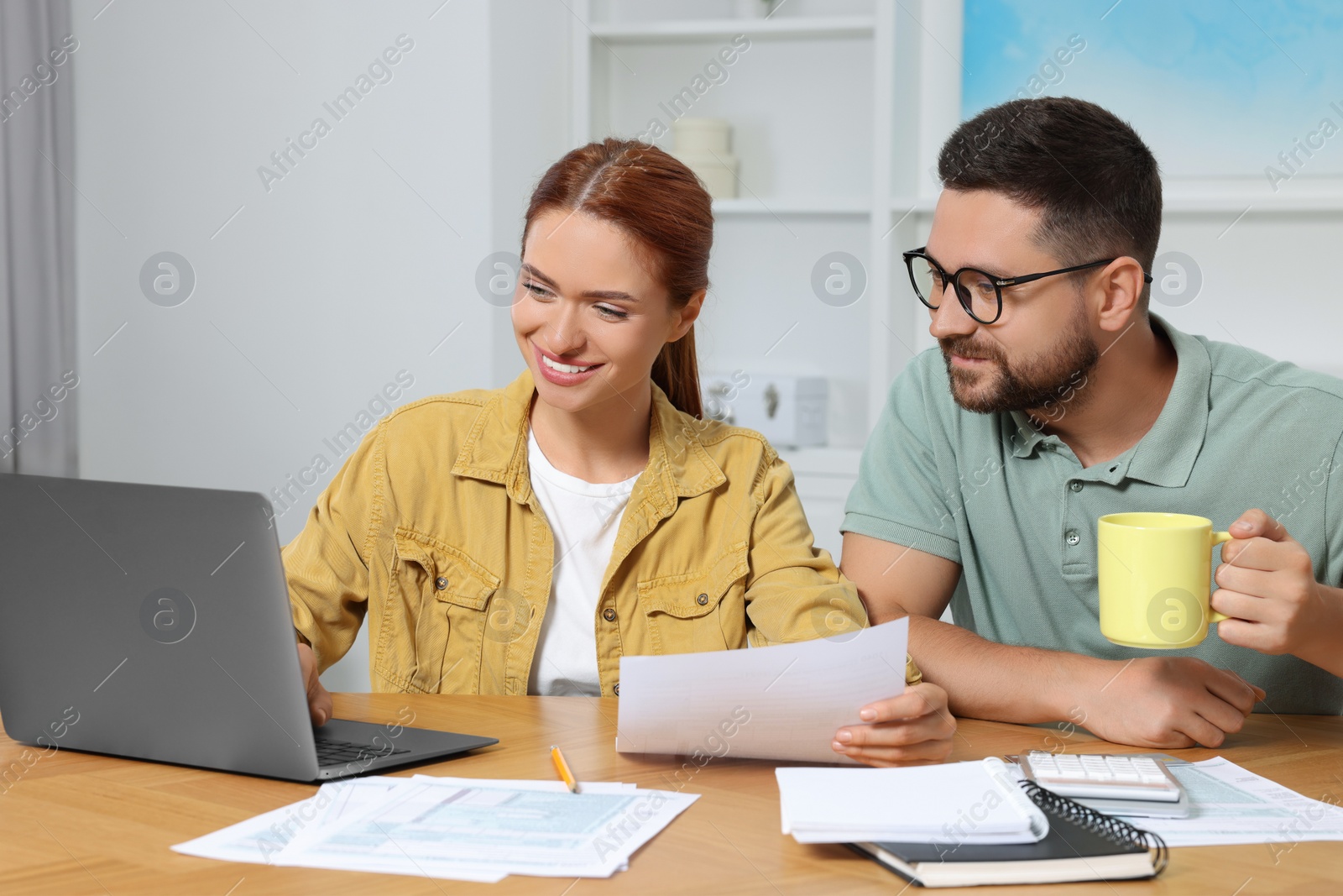 Photo of Couple doing taxes at table in room