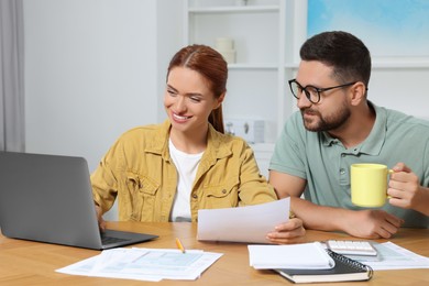 Couple doing taxes at table in room