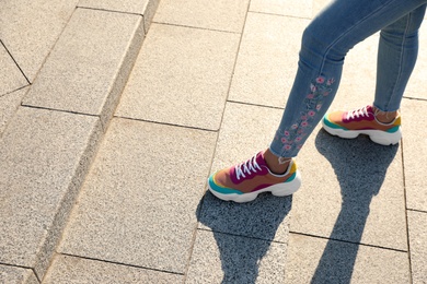 Photo of Woman on stairs outdoors, closeup with space for text. Choosing way concept.