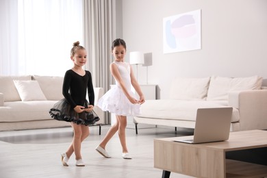 Cute little girls taking online dance class at home