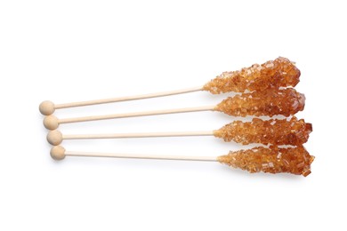Wooden sticks with sugar crystals isolated on white, top view. Tasty rock candies