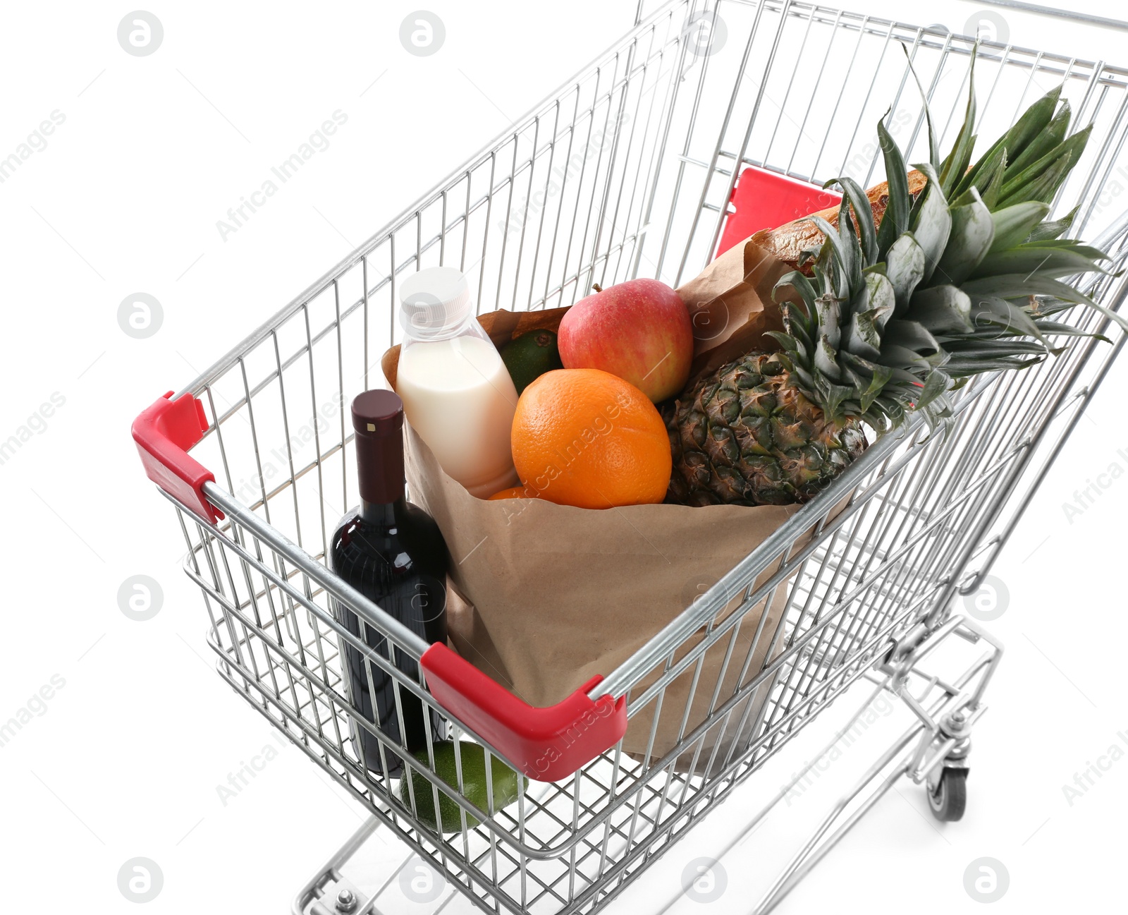 Photo of Shopping cart with groceries on white background