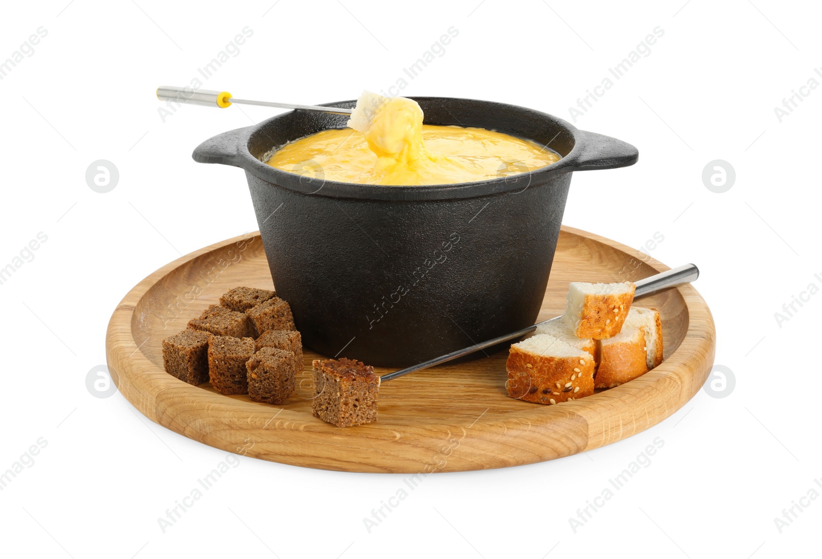 Photo of Fondue with tasty melted cheese, forks and pieces of bread isolated on white