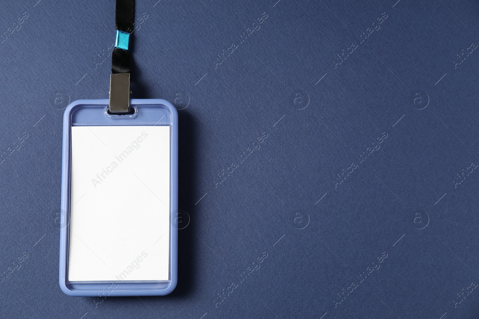 Photo of Blank badge with string on blue background, top view. Space for text