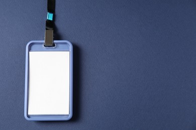 Photo of Blank badge with string on blue background, top view. Space for text