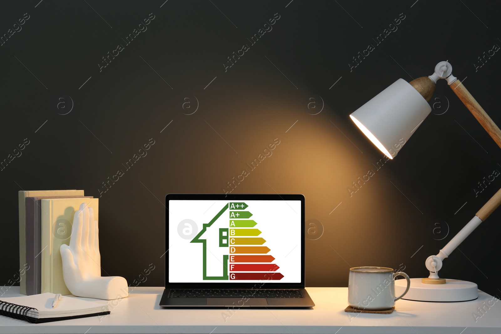 Image of Energy efficiency rating on laptop display. Workplace with modern computer