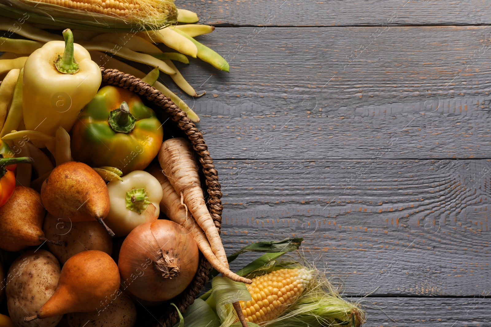 Photo of Different fresh ripe vegetables and fruits on grey wooden table, flat lay. Space for text