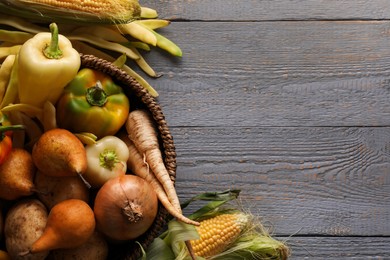 Different fresh ripe vegetables and fruits on grey wooden table, flat lay. Space for text