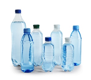 Photo of Set of different plastic bottles with water on white background