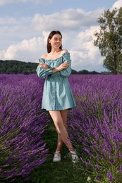 Photo of Full length portrait of smiling woman in lavender field