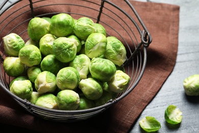 Basket with fresh Brussels sprouts on table, closeup