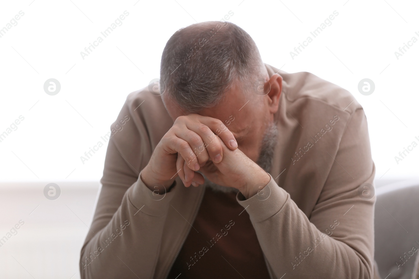 Photo of Senior man in state of depression indoors