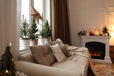 Fireplace in room with Christmas decorations. Interior design