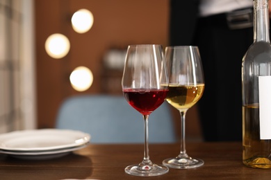 Photo of Glasses with tasty wine on table in restaurant