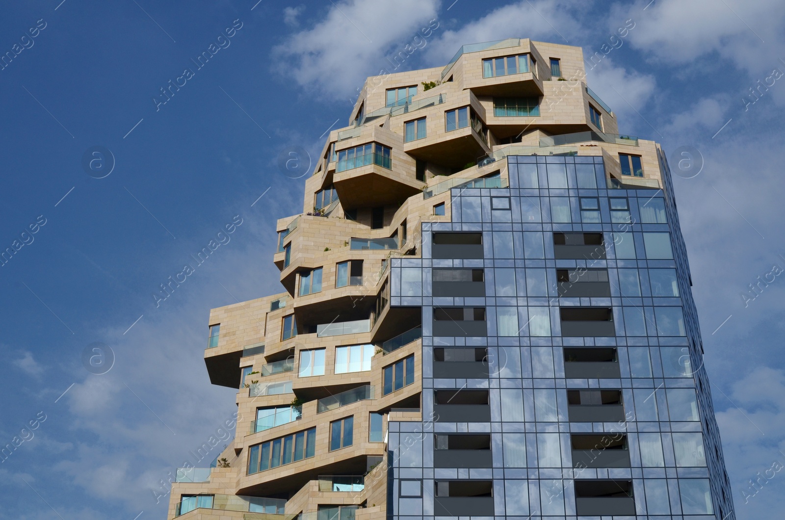 Photo of Exterior of beautiful modern skyscraper against blue sky