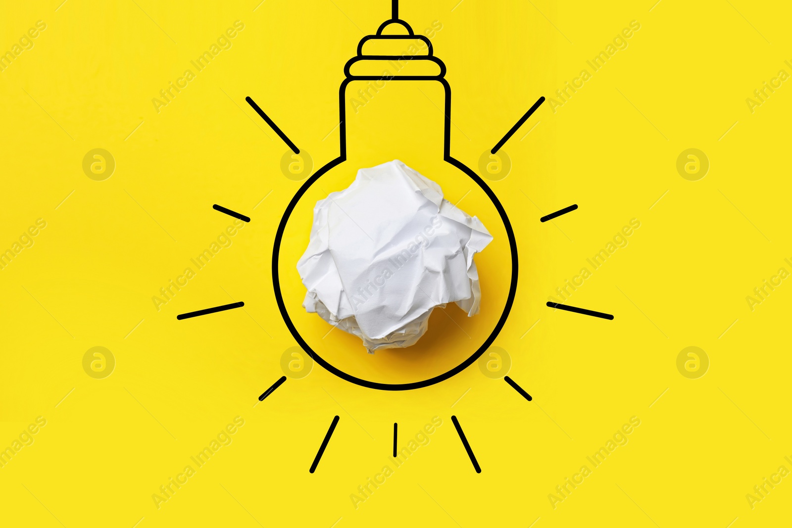 Image of Idea. Illustration of light bulb around crumpled paper ball on yellow background, top view