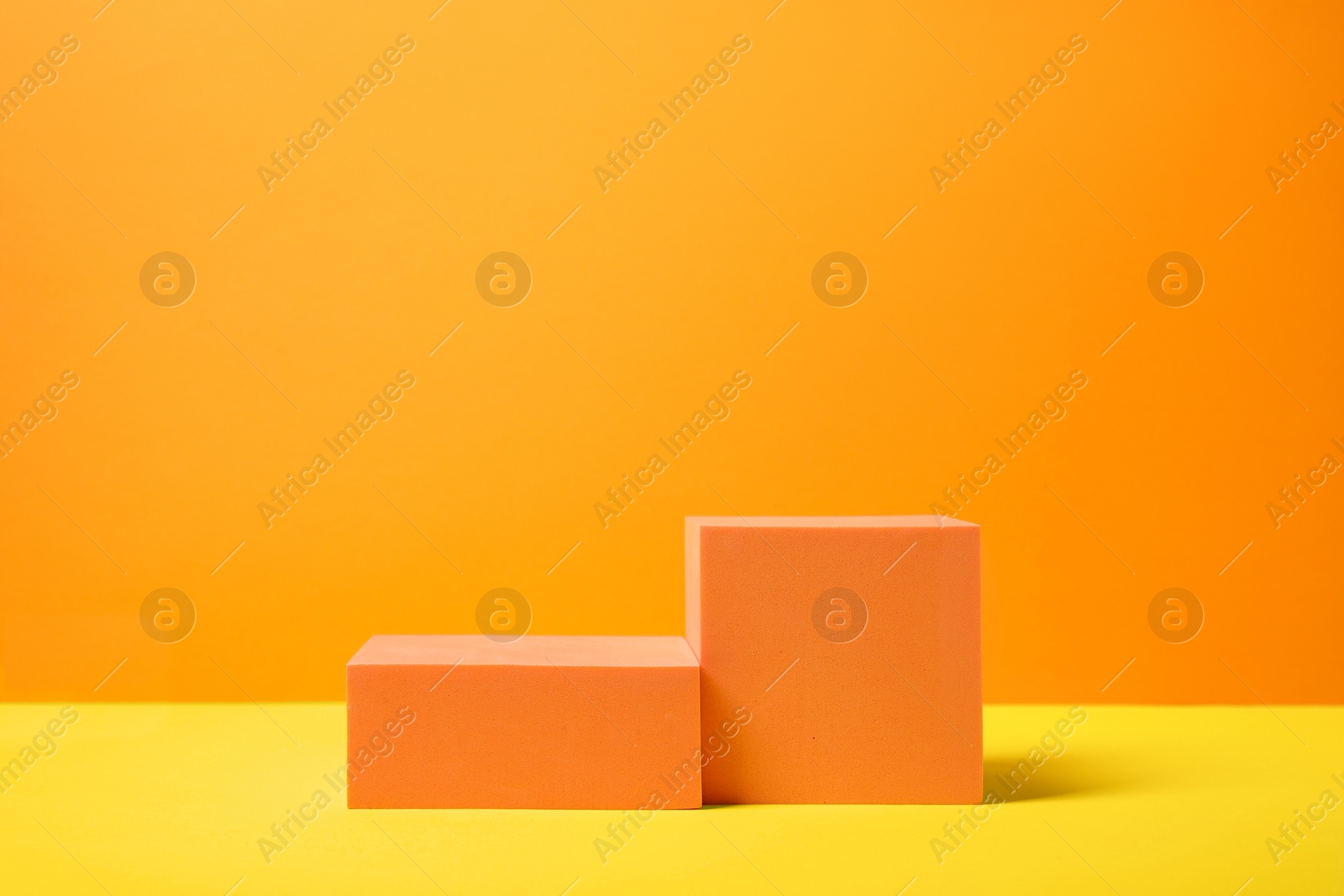 Photo of Geometric figures on orange background, space for text. Stylish presentation for product