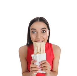 Young woman eating delicious shawarma on white background