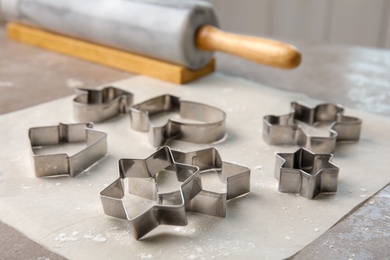 Photo of Cutters for homemade Christmas cookies on table