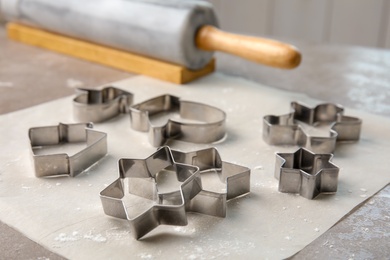 Cutters for homemade Christmas cookies on table