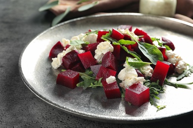 Plate with delicious beet salad on table, closeup