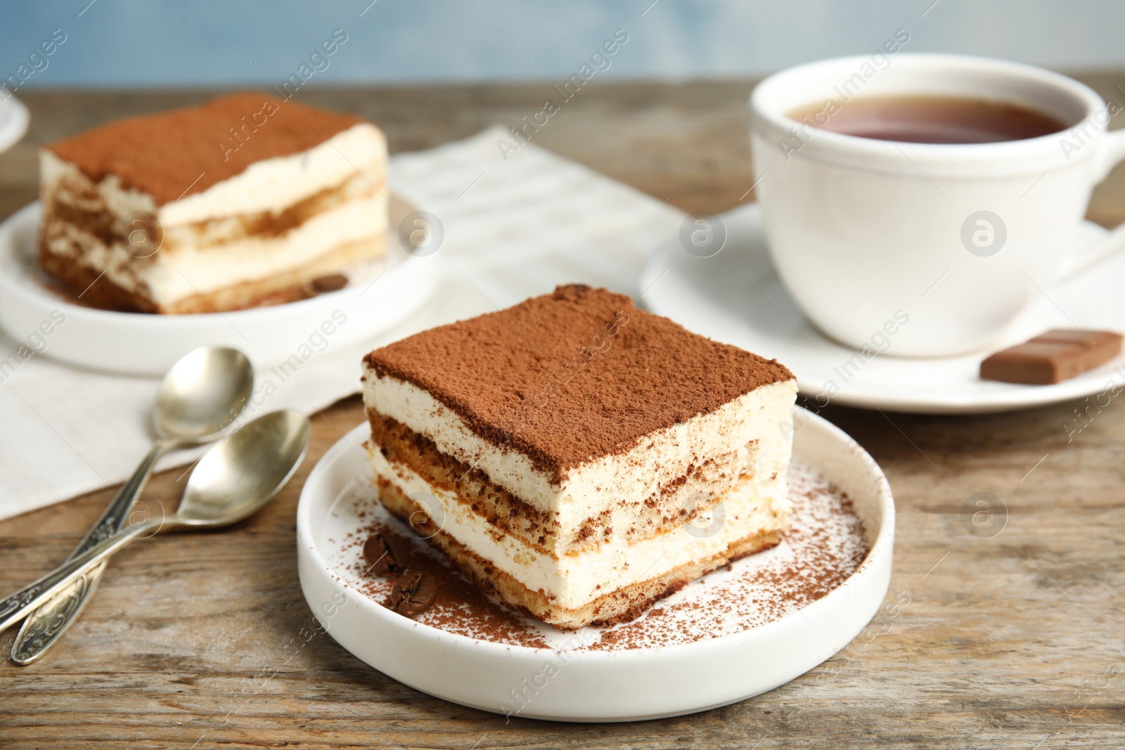 Photo of Composition with tiramisu cakes and tea on table