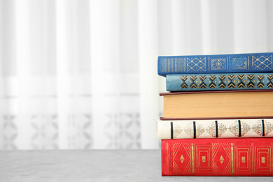 Collection of different books on table indoors. Space for text